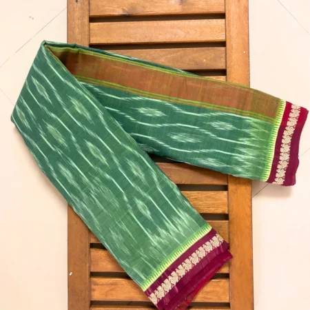 Sage green handloom ikkat saree with plum wine border featuring woven bird motifs and temple design